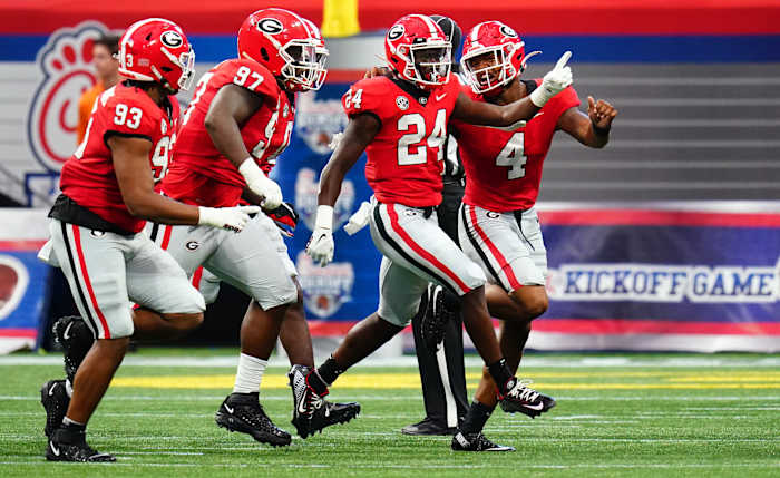 Sep 3, 2022; Atlanta, Georgia, USA; Georgia Bulldogs defensive back Malaki Starks (24) celebrates his interception against Oregon Ducks wide receiver Seven McGee (7) during the first quarter of the Chick-fil-A kickoff game at Mercedes-Benz Stadium. Credit: John David Mercer-USA TODAY Sports